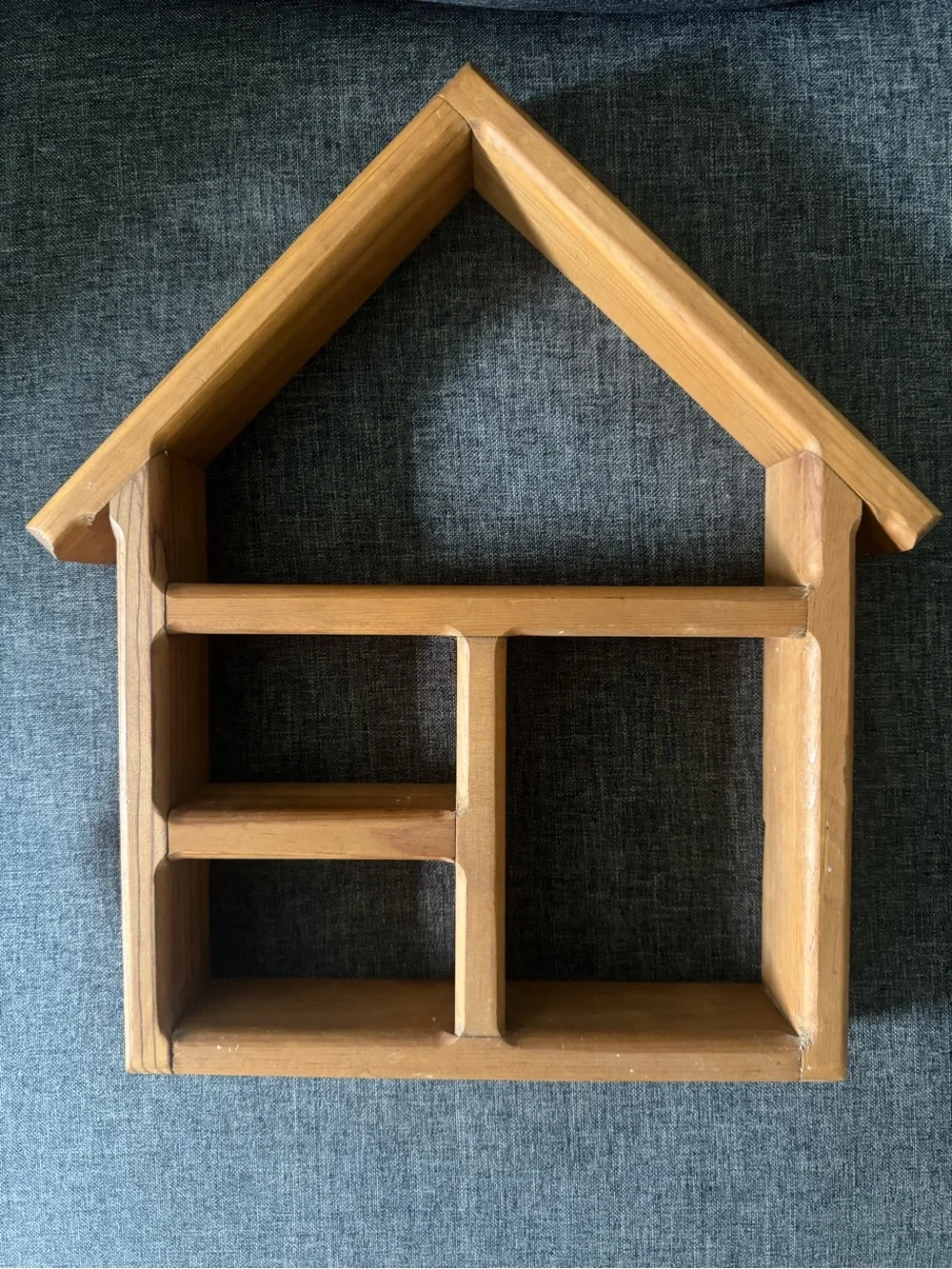 This vintage house-shaped wooden wall display shelf